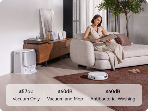 Woman sitting on a couch reading a book with Narwal Flow robot vacuum cleaner in the foreground, showing different noise level labels.